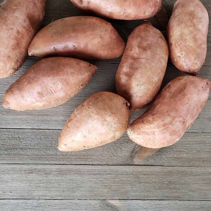 Sweet potatoes on a wooden surface