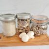 Jars of mushroom powder, dried mushroom slices and dehydrated mushroom chips