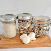 Jars of mushroom powder, dried mushroom slices and dehydrated mushroom chips
