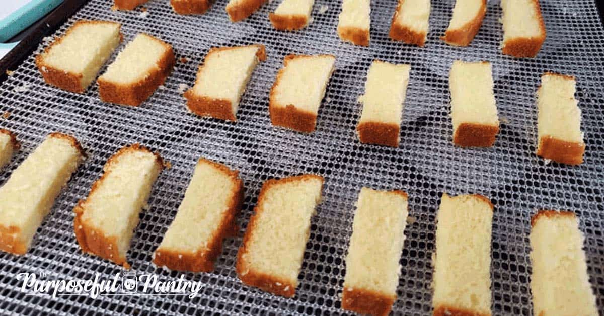 pound cake slices on a dehydrator tray to be dehydrated for diy biscotti