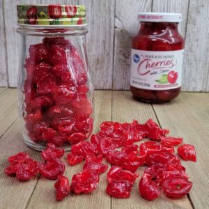 Jar of dehydrated maraschino cherries along with a commercial jar of them.