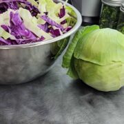 Bowl of sliced cabbage and cabbage head for dehydrating