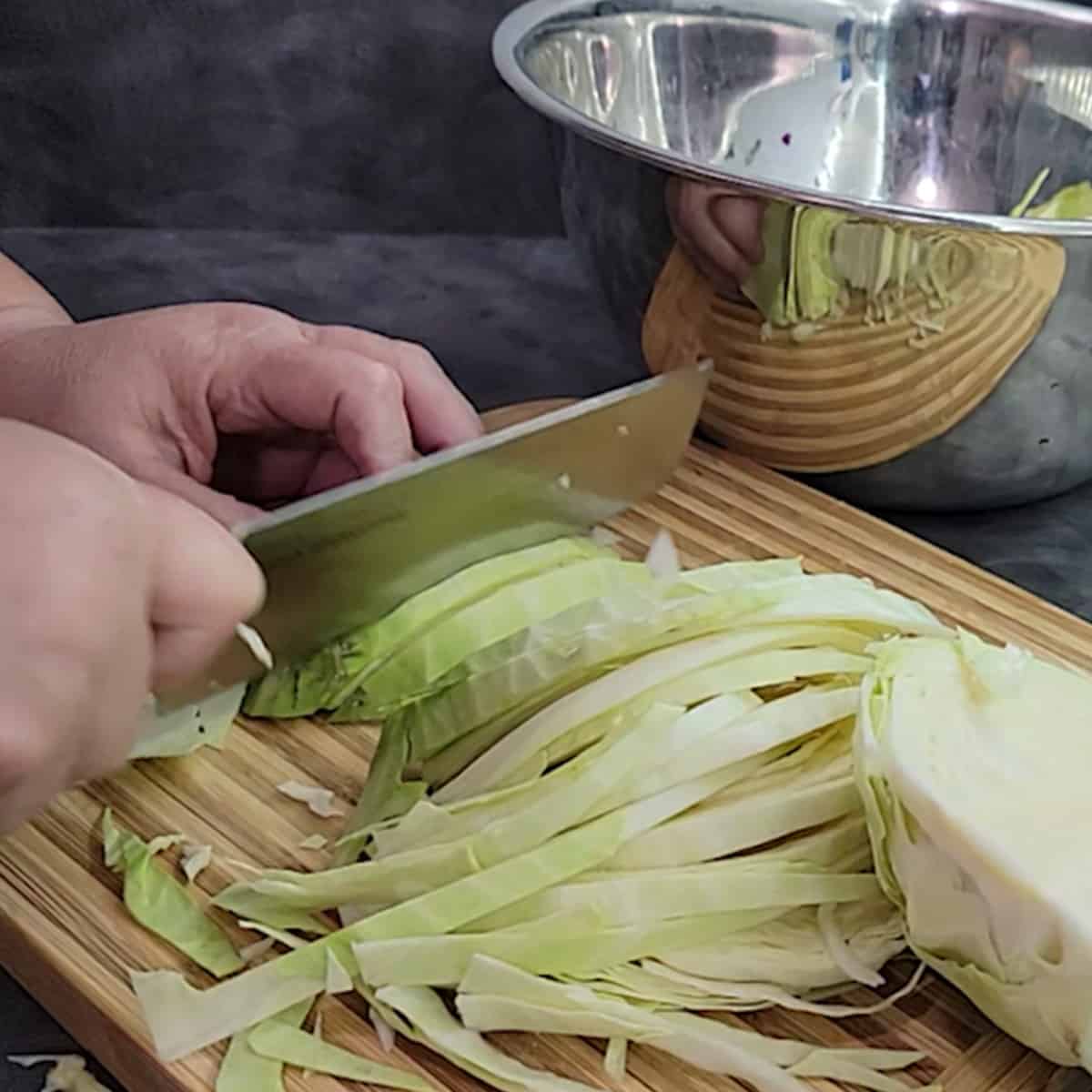 Cabbage head being sliced in preparation for dehydrating