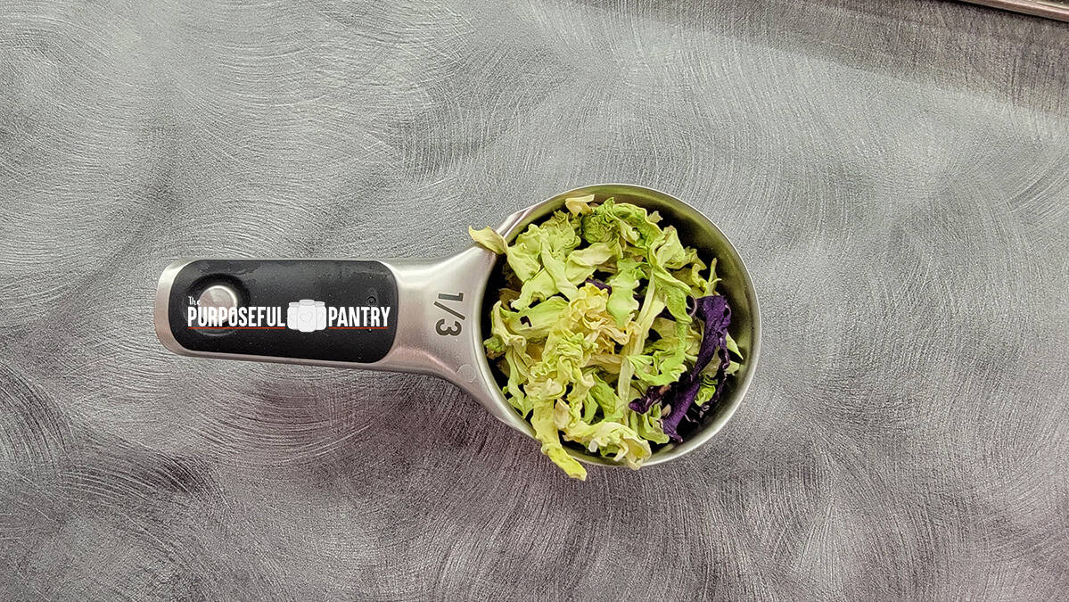 Dehydrated cabbage in a 1/3 cup measure to show drying yield