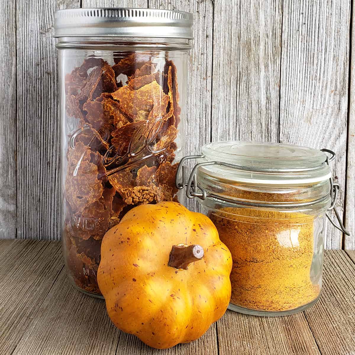 Pumpkin leather and pumpkin powder in jars with a decorative pumpkin