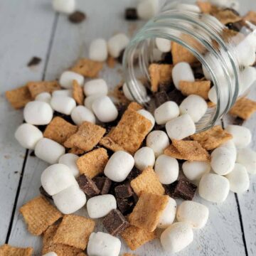 Close up of Crunchy S'more Trail Mix spilling out on a table top.