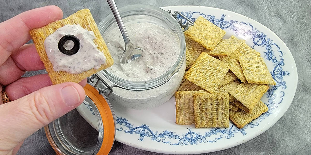 Olive Powder spread serving suggestion: Triscuit Smoked Gouda cracker, and dehydrated olive slices