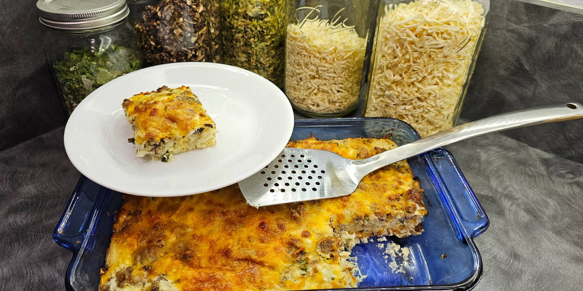 Hashbrown breakfast casserole serving on a plate on top of the casserole platter.