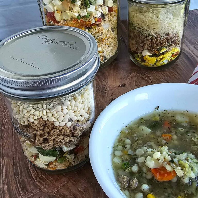 Meals in a jar of instant beef and vegetable soup; one with rice, one with pasta, one with couscous.
