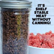A jar of dehydrated ground beef with a bowl of raw ground beef in the background.
