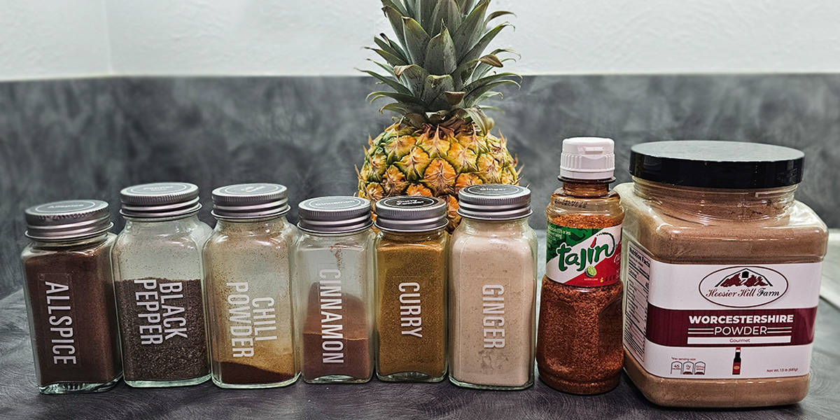 Jars of different seasonings to use with dehydrated pineapple