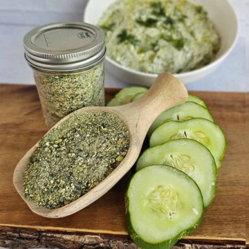 Dehydrated tzatziki mix with fresh cucumbers and a bowl of tzatziki in background.