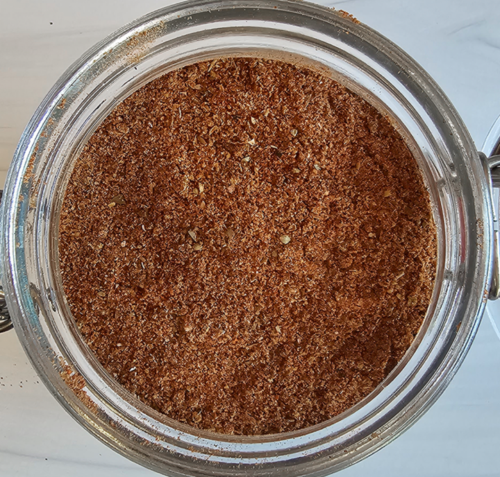 Glass jar of bulk diy taco seasoning mix from above.