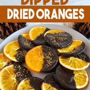 Chocolate dipped dried oranges on a plate.
