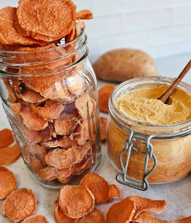 Sweet potato chips in a jar with a wooden spoon.