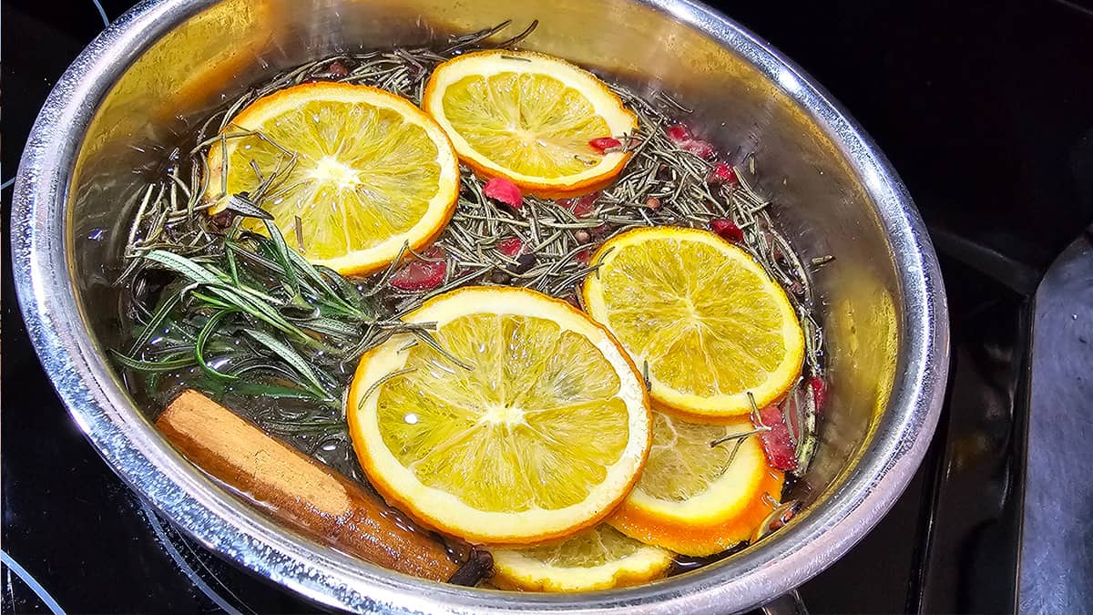 A pot filled with dried orange slices and cinnamon sticks.