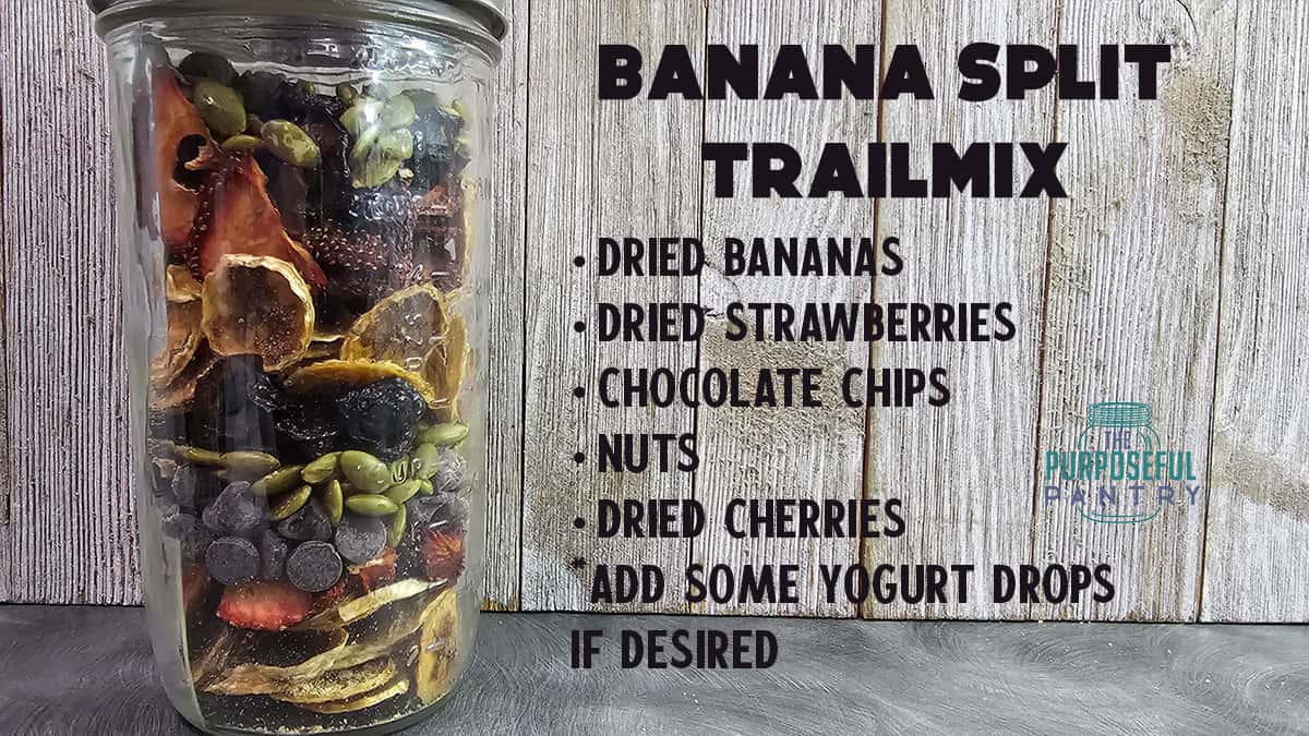 A jar full of dried fruit and nuts in front of a wooden background.