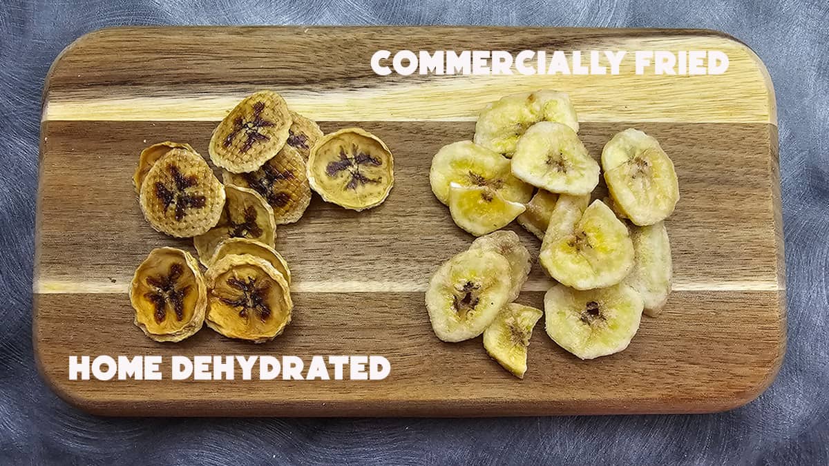 A wooden board with slices of home dried bananas and commercially dried bananas.