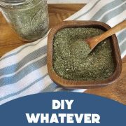 Wooden bowl filled with green seasoning blend with a wooden spoon on a cloth. A mason jar of the same blend is seen beside the bowl. Text on the image reads, "Goodbye, Mrs. Dash!" and "DIY Whatever Seasoning Blend.